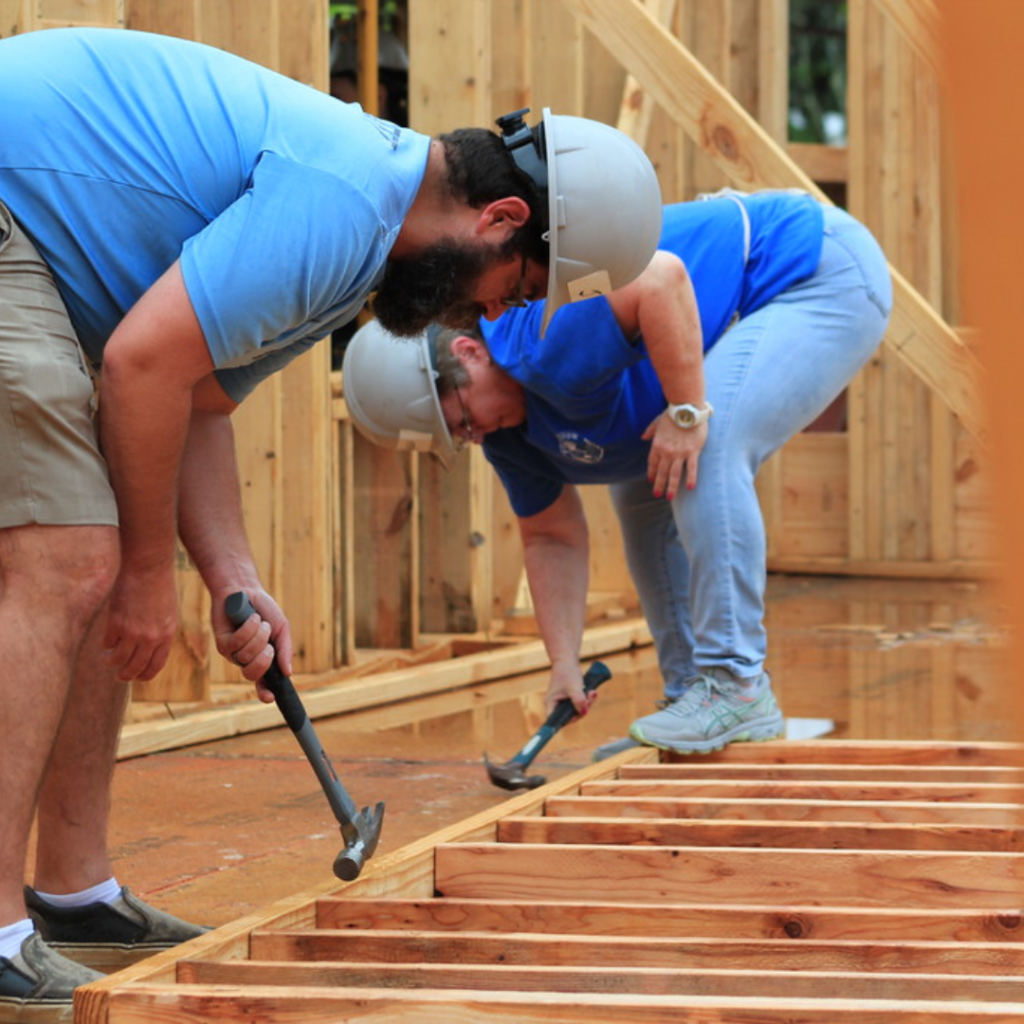 people hammering wood