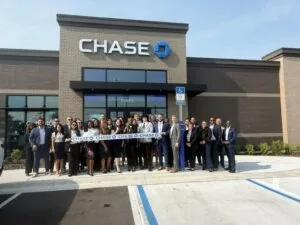 Group of people at Chase Bank grand opening in Atlantic North Shopping Center.