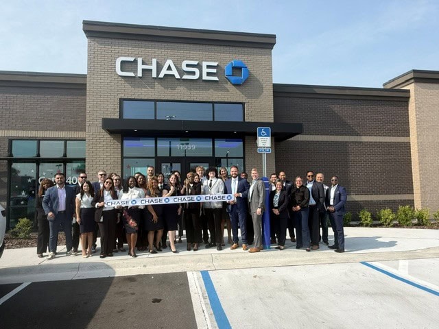 Group of people at Chase Bank grand opening in Atlantic North Shopping Center.