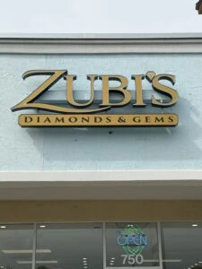 ZUBIS Diamonds & Gems sign on the store exterior with an open sign below.