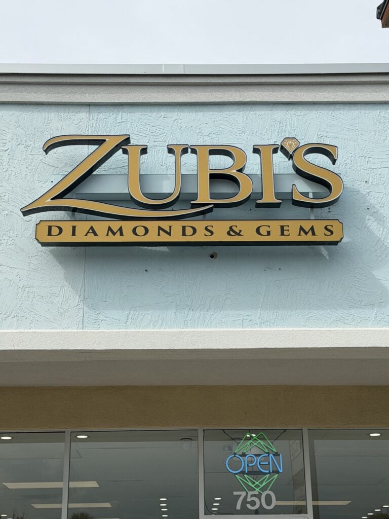ZUBIS Diamonds & Gems sign on the store exterior with an open sign below.