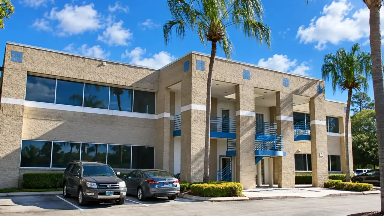 Salisbury Lakes Office Building with palm trees and parking lot.